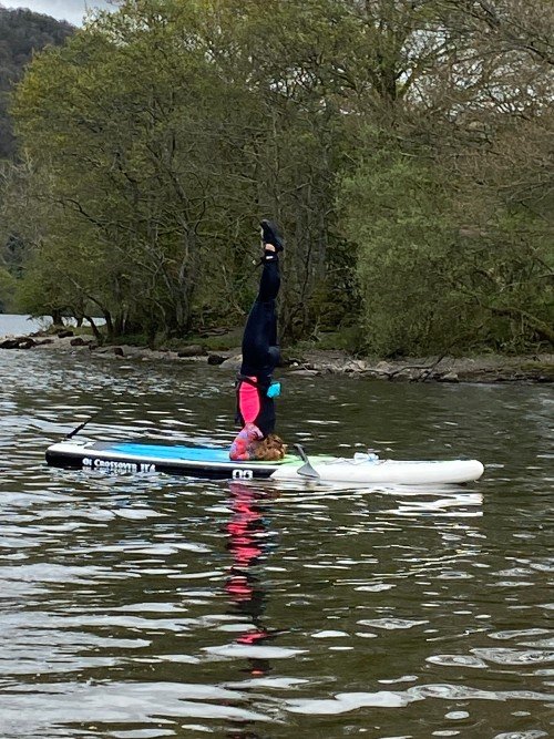 Amanda Alexander doing a headstand on a paddleboard