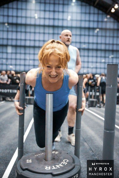 Amanda Alexander pushing a sled during outdoor fitness training