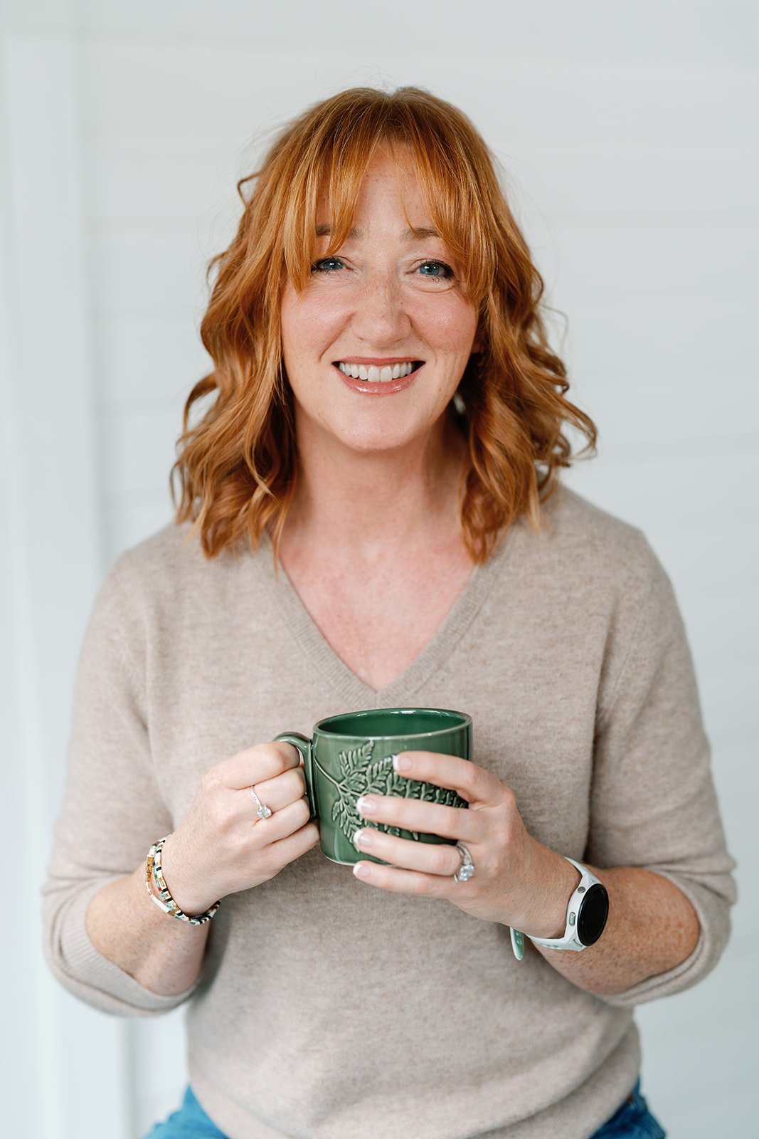Amanda Alexander, executive coach, holding a green mug